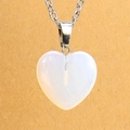 Macro detail of the faceted heart-shaped opal pendant with a sleek silver-tone chain - Opalite