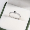 Macro shot of silver crystal ring with square setting in a green velvet jewelry box - Platinum E
