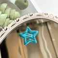 Sparkly blue-green star hair clip with glitter finish on a decorative mirror surface - Aqua Blue Glitter