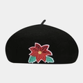 Detailed view of black wool beret featuring a red sequined poinsettia flower and green leaves - M / Poinsettia Pattern Black