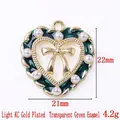 KC gold heart charm with white pearls, green enamel, and a bow, 21x22mm size - 13822-KC Gold Plated-Transparent Green Enamel Heart Bow