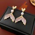 Detail of heart stud earrings with pearls and purple enamel mermaid tails on black box - Purple Fish Tail Drop Earrings (Silver Pin)
