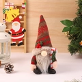 Close-up of Christmas gnome with knitted snowflake hat holding a red candy cane - Male Style With Cane (A2-2)
