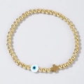 Dettaglio del bracciale dorato con perline e ciondolo a croce con occhio greco blu - Occhio Blu Scuro-Oro (JS-B24070302D)