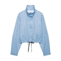 Detail of light blue polka dot jacket featuring a high collar and adjustable drawstring hem - Blue Polka Dot Top