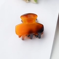 Tortoiseshell patterned resin hair claw clip with metallic spring for daily hair styling - Amber