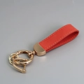 Elegant red suede leather keychain with polished gold hardware and anti-loss D-ring loop - Red/Gold