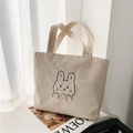 Close-up of cream corduroy tote bag with cute cartoon rabbit and carrot embroidery - Rabbit Carrot White