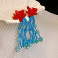 Close-up detail of handmade red flower earrings featuring elegant long blue seed bead tassels - Petal Seed Bead Tassel Earrings (16#) / Red Blue