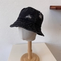 Black vintage distressed denim bucket hat with frayed holes on a white head model - One Size / Black