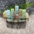 Macro shot of handmade hair comb with amazonite stones and sun charm on mossy rock - Amazon Stone Black Wire Silver Sun