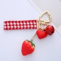 Detailed view of cute red strawberry keychain with heart charm and houndstooth strap - Heart Bell Strawberry / Single OPP Bag Packaging