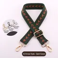 Detailed view of dark green arrow pattern bag strap with gold, black, and silver hardware - Dark Green
