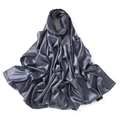 Detailed view of the smooth grey satin scarf showing its glossy silk-like texture and folds - Morandi