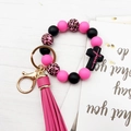 Close-up of pink and leopard print silicone beads with Jesus cross charm and tassel keychain - Pink Black