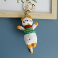 Handmade crochet cat keychain in orange and white with a green vest and golden bell - Emerald Green Vest Cat