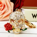 Portachiavi teschio dorato scintillante con rosa rossa e strass per borsa o chiavi auto - Zircone Bianco