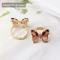 Verstellbarer goldener Schmetterlingsring mit rotbraunen Kristallen und Diamantakzenten - Rotbraun
