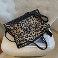 Trendy leopard print shoulder bag with silver rivets and black fringe tassel charm - Black