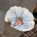 Close-up of blue and white checkered scrunchie with detailed white lace edges - Blue Plaid