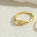 Detailed view of a gold evil eye ring with sparkling zircon inlays on textured background - White Zirconia (JZ0999-2)