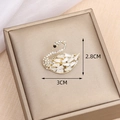 Golden swan brooch inlaid with white zircons and black eye detail, size 3.0cm x 2.8cm - Swan