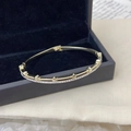 Elegante bracciale rigido dorato con file di zirconi bianchi e motivi a stella - Stella Doppia