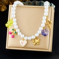 Detail of beaded necklace with pearl chain and colorful cherry, bear and star pendants - Necklace (N3777)