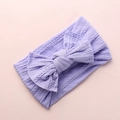 Detail of purple knitted nylon baby headband with soft cable stitch texture and bow - Purple
