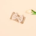 Detail of high-elasticity nylon baby headband with a soft pink 3D bow and knit texture - Dark Beige Pink