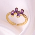 Detailed macro view of gold plated ring with four rectangular purple zircons on silk - Adjustable Open / Purple Rhinestone