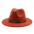 Detailed macro of orange felt fedora with a bronze studded band and metallic badge - M(56-58cm) / Brick Red