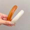 Sleek curved spring hair clips in amber and white marble finish for elegant styling - Amber + Mermaid White