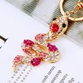 Detailed macro view of snake keychain with sparkling pink rhinestones and gold alloy hook - Rose Pink Snake
