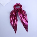 Detail of fuchsia sequin scrunchie with long ribbons and shimmering metallic finish - Rose Red