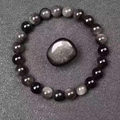 Polished natural black obsidian bead bracelet featuring a smooth round stone focal point - Silver Obsidian