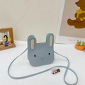 Detailed view of a small blue bunny PU leather shoulder bag for toddlers on a white desk - Square Blue