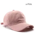 Retro corduroy baseball cap in pink color featuring a curved brim and striped texture - Pink