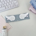Detail of fabric cable organizer with plush angel wings on a light blue denim strap - Denim Star Light Blue