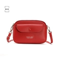 Detailed view of red lychee textured leather mobile phone bag with silver metal hooks - Red