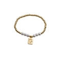 Detail view of pearl and gold bead bracelet featuring an engraved G letter pendant - Letter G