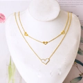 Double-layered gold-plated butterfly necklace with white heart pendant on a model neck - Heart