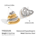 Macro view of heart-shaped two-tone stainless steel earrings with wavy layered design - Gold and Silver Two-Tone Heart Style (YYE025195)
