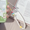 Detail of beaded phone strap with colorful heart charms and LOVE letter beads on white cord - Rainbow White Polymer Clay Lanyard