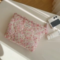 Detail view of quilted cotton makeup bag with pink floral patterns on a sunlit desk - Pink Ditsy Floral