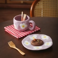 Detail of lavender ceramic cup and saucer set with floral pattern in a cozy setting - 340ml / Purple Frangipani