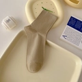 Ribbed mid-calf cotton socks in creamy khaki color on a minimalist aesthetic tray - One Size / Khaki
