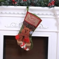 Vintage Christmas stocking with reindeer plush and candy cane decor on white fireplace - Embroidered Reindeer with Candy Cane