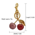 Glitter cherry keychain charm with dimensions 13.5cm x 7.5cm and gold metal clasp detail - Champagne Red with Gold Plated Leaf