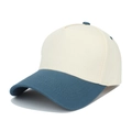 Detail of the two-tone baseball cap featuring cream crown and navy blue curved visor - Beige/Royal Blue